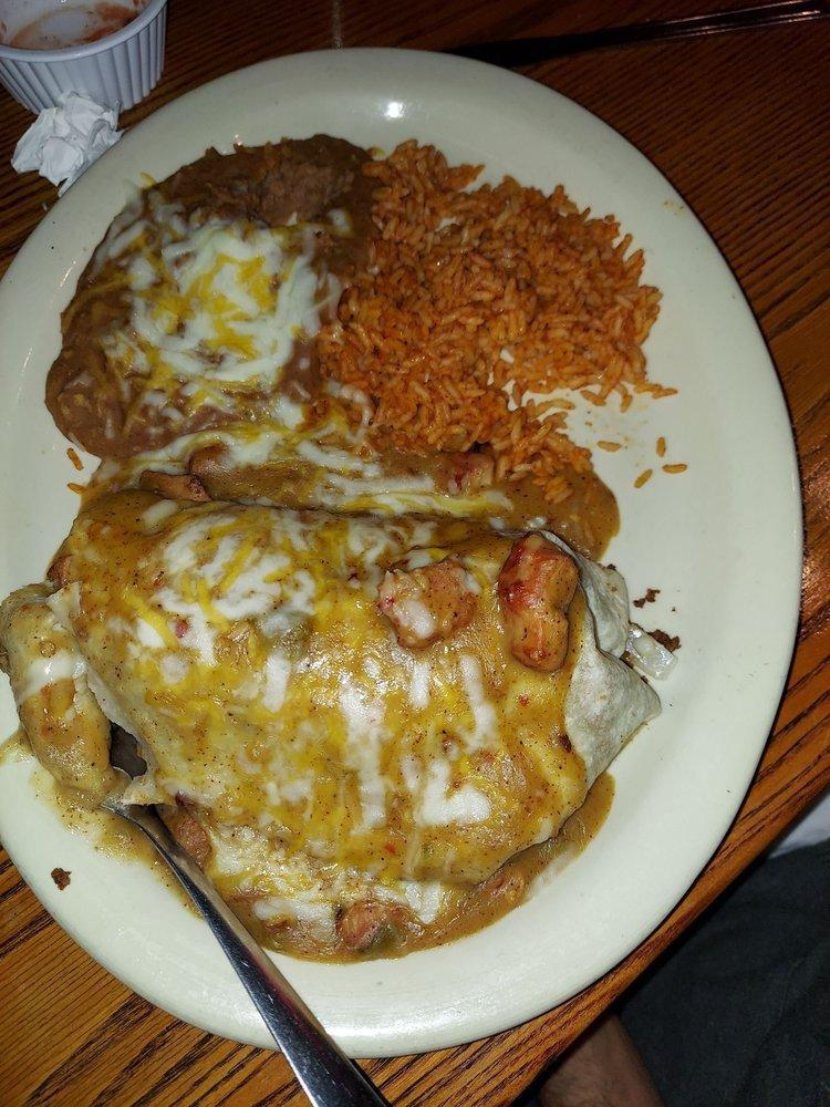 Supreme Burrito · Ground beef, rice, beans, onions, and cheese smothered with our pork green chili sauce and sour cream.