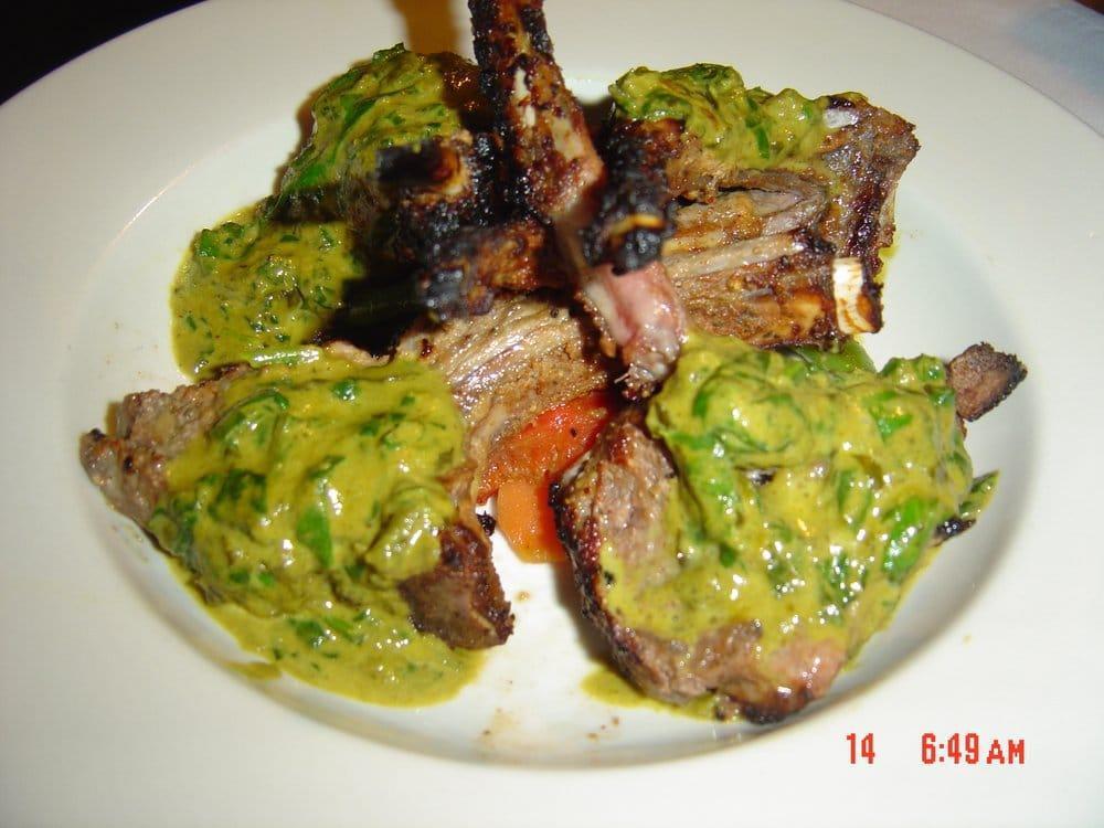 Kitchen Special · Rack of lamb marinated in yogurt, with pepper, lemon juice, light herbs and spices. Cooked in a clay pot and served with spinach sauce. Served with basmati rice.
