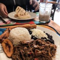 Pabellon Criollo · Shredded beef, white rice, black beans sprinkled with grated white cheese and fried sweet pl...
