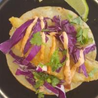 Baja Fish Taco · Crispy fried fish topped with shredded red cabbage, fresh cilantro and a creamy chipotle sau...