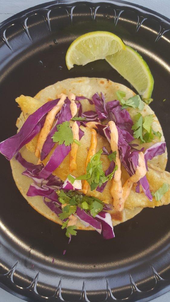 Baja Fish Taco · Crispy fried fish topped with shredded red cabbage, fresh cilantro and a creamy chipotle sauce.