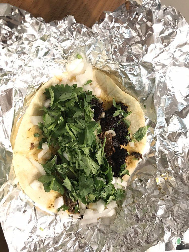 Barbacoa Taco · Slow roasted marinated beef topped with fresh onion and cilantro.