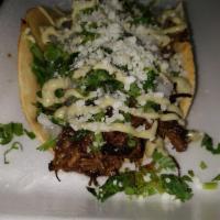 Brisket Taco · Smoked beef brisket seasoned with Dave's rub, topped with fresh onions, cilantro, cotija che...