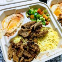 Gyro Plate · Gyro meat, basmati rice, house salad, hummus dip, pita bread, and tzatziki sauce.
