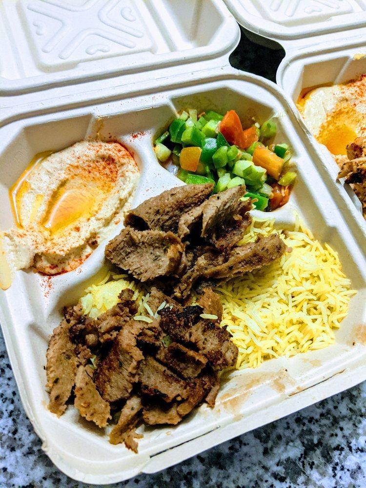 Gyro Plate · Gyro meat, basmati rice, house salad, hummus dip, pita bread, and tzatziki sauce.
