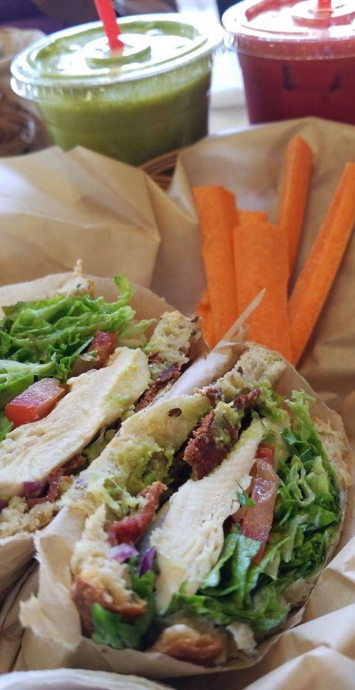 California Chicken Club · Organic chicken breast, green leaf lettuce, avocado, tomato, turkey bacon, red onion and low-fat mayo on flatbread. Served with chips and carrot sticks.