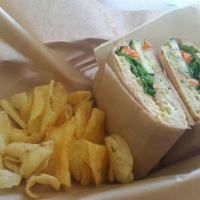 Ultimate Veggie Sandwich · Hummus, avocado, spinach, cucumber, tomato, carrots on wheat. Served with chips and carrot s...