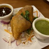 Samosa · Hand rolled pastry stuffed with potato and green peas.