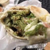 Falafel Wrap · Our falafel inside of a pita wrap with lettuce, tomatoes, onions, pickles, parsley and tahin...