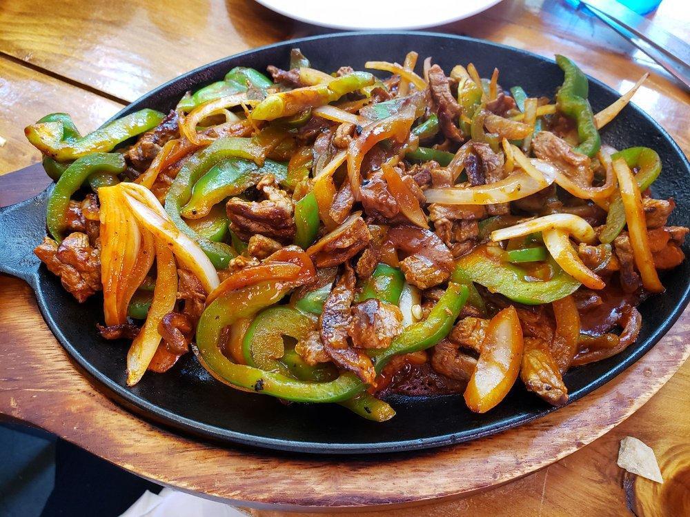 Fajitas · Your choice of chicken, steak, shrimp, or veggies.  with roasted bell peppers and onions. Served flambé with Mexican rice, black beans, guacamole, sour cream, pico de gallo and tortillas.