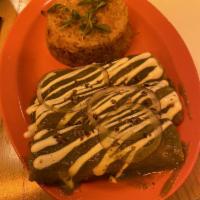 Enchiladas Mole · Shredded palm carnitas, coconut queso, guajillo pepper, sour cream, served with Spanish rice...