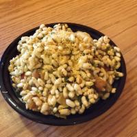 Bhel Puri · Rice puffs, crispy noodles, potatoes, green chili, onions, cilantro tossed with tamarind and...