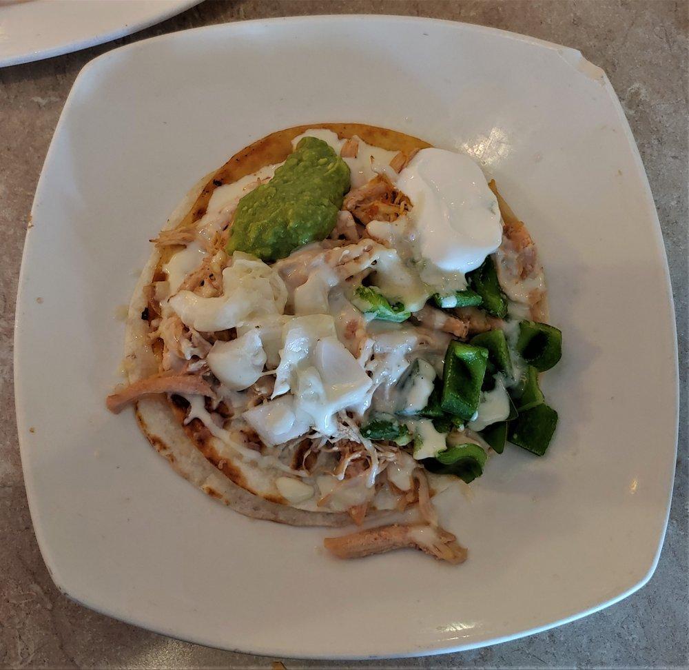 Mexican Pizza · 2 Flour tortillas filled with cheese, beans and topped with your choice of chicken or beef and peppers, onions, sour cream guacamole and cheese sauce.