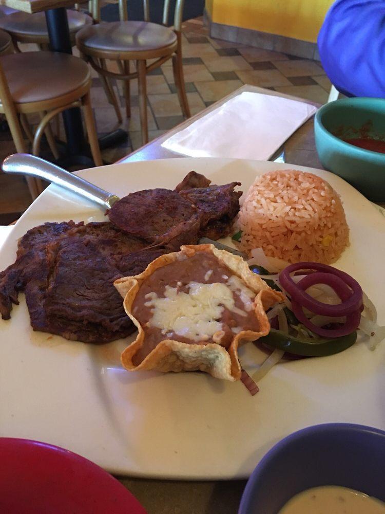Carne Asada · Grilled rib-eye steak served with rice, beans and 3 tortillas.