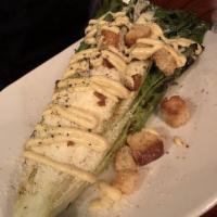 Grilled Caesar Salad · Grilled romaine, Parmesan, croutons, garlic Caesar dressing.