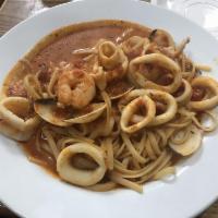Linguini Pescatore · Linguini with shrimp, clams and calamari in a wine garlic tomato sauce.