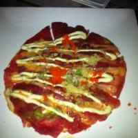 Tuna Pizza · Guacamole on a toasted tortilla. Topped with sliced fresh tuna and garnished with tobiko, sc...