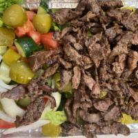 Beef Shawarma Plate · Served with garden salad, rice and pita bread. Includes choice of sauce.