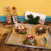 Tres Tacos · Pickled red onions, salsa verde, queso fresco, organic radishes, and fresh cilantro.