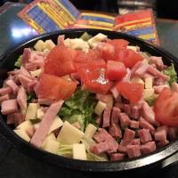 Antipasto Salad · Romaine/Iceberg blend. Ham, salami, provolone cheese and tomatoes. Side of homemade Italian ...