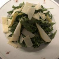 Insalata Romana · Arugula, fresh pear, fennel and Parmigiano cheese in lemon dressing.