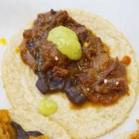 Steak Picado · Flank steak simmered with green bell peppers and bacon. Served with green serrano chile atop...