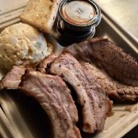 Baby Back Ribs · Baby back ribs served with garlic bread and your choice of a side dish