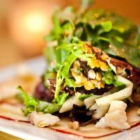 Apple Salad · Mixed greens, pomegranate, walnuts and Taleggio cheese with apple dressing.
