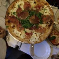 Prosciutto Pizza · Prosciutto di Parma, arugula, mozzarella and Parmigiano.