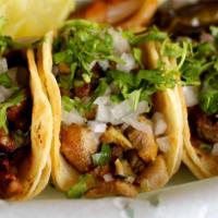 Mini Taco · Meat, onions and cilantro on 2 corn tortillas.