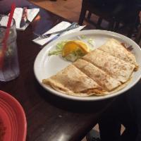 Quesadillas · King size flour tortilla filled with melted Monterey jack cheese, garnished with guacamole a...