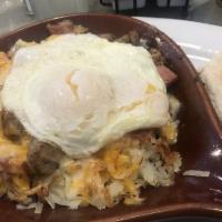 Ham, Sausage & Mushroom Skillet · Topped with 2 eggs, melted cheese, hash browns, and English muffin.