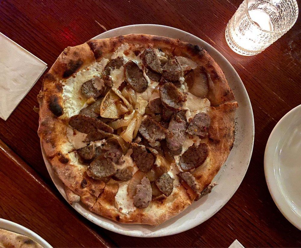 Wiseguy Pizza · Served with house-smoked mozzarella, wood-roasted onion, and fennel sausage.