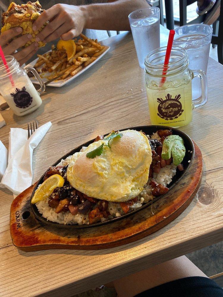 Mexipino Hash Plate · Achiote chicken, longanisa, potatoes, ham, rice, black beans, purple yam, avocado and queso fresco. 