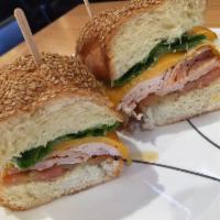 Turkey Melt · Cracked pepper turkey and melted cheddar cheese topped with romaine lettuce, plump tomato, r...