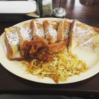 French Toast · Topped with cinnamon and powder sugar, served with eggs and bacon.