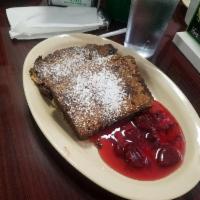 Banana Nut Bread French Toast · 2 pieces banana nut, French toast tossed, covered with fruit and sprinkled with powdered sug...