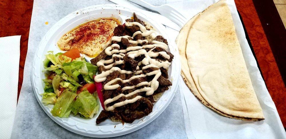 Beef Shawarma Wrap · Thin slices of beef marinated and seasoned with a special blend of spices, topped with tahini sauce and tomatoes.