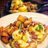 Eggs Benedict · 2 poached eggs, Nueske's shaved ham, Hollandaise on top of a toasted English muffin and serv...