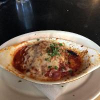 Lasagna · Layered sheets of pasta with meatballs, Italian sausage, herbed ricotta cheese, and topped w...