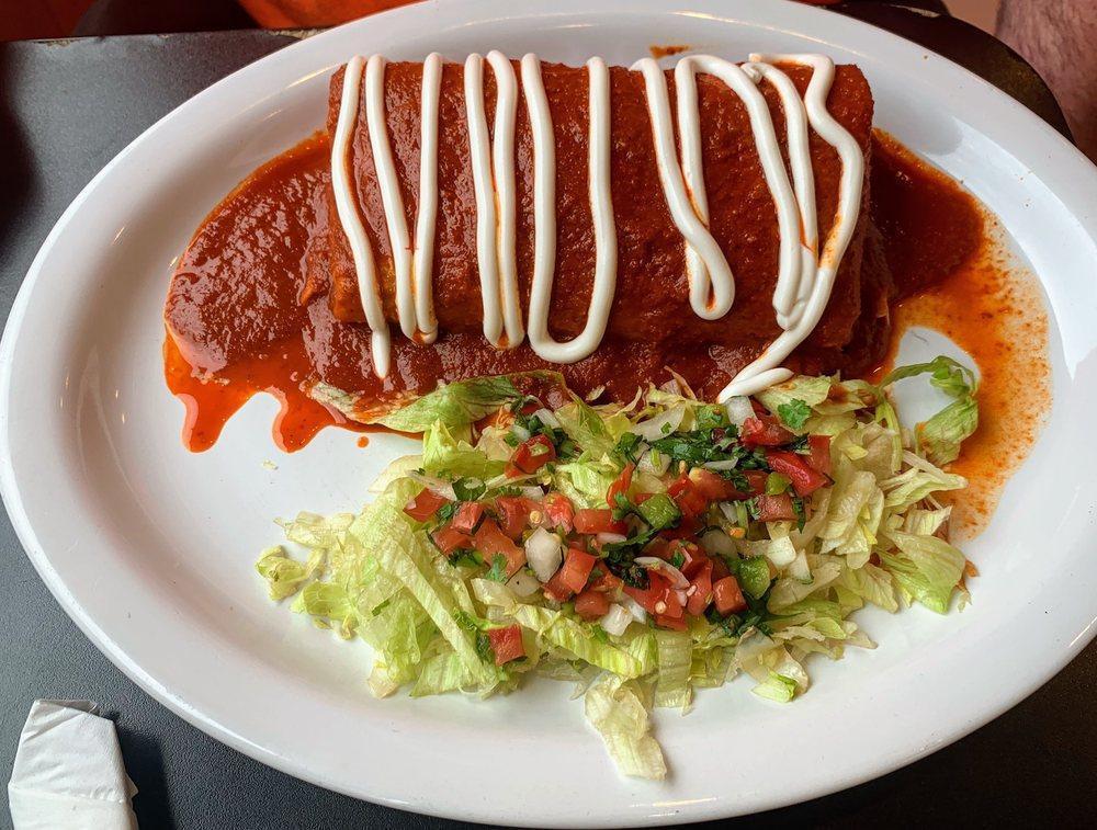 Wet Burrito · Beans, rice & your choice of meat, topped with homemade red enchilada sauce, sour cream, a side of lettuce & salsa fresca.
