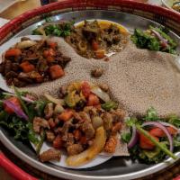 Doro Wot · Meticulously prepared chicken with diced red onions and simmered in a tastefully seasoned be...
