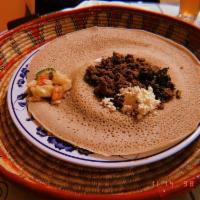 Kitfo · House specialty, finely chopped beef seasoned with mitmita and  topped with seasoned clarifi...