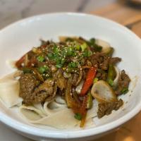 Tingly Beef Noodles · Hand ripped noodles mixed with spicy chunks of lean beef.