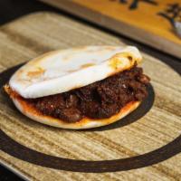 Mount Qi Rougamo · Stewed spicy pork belly packed into a warm and crispy flatbread like a bun.