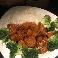 Sesame Chicken · Battered chicken breast coated with tangy sesame sauce with steamed broccoli.