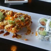 Volcano Roll · Crab stick, cucumber, avocado topped with baked spicy seafood salad, spicy mayo, eel sauce, ...