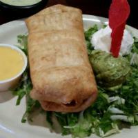Chimichanga · Deep-fried flour tortilla filled with ground beef or shredded chicken. Served with guacamole...
