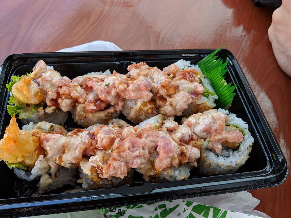 Dragon Maki · 8 pieces. Shrimp tempura, lettuce, teriyaki sauce, sesame seeds, ground ahi, green onion. tobiko and spicy sauce, masago.