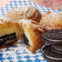 4 Deep Fried Oreos · Classic oreo cookies coated deep fried to perfection and sprinkled with powdered sugar.